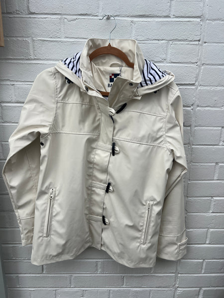 White raincoat with striped lining and toggle closure