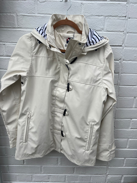 White raincoat with striped lining and toggle closure
